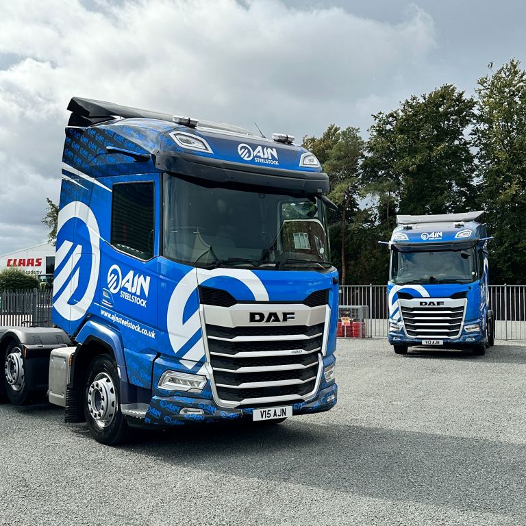 Two DAF trucks from the AJN Steelstock fleet, featuring identical custom vehicle wraps designed and applied by Indigo Ross to ensure consistent fleet branding