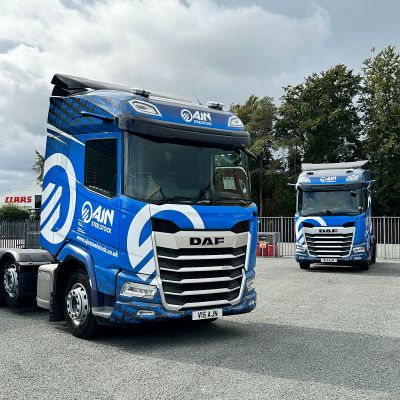 Two DAF trucks from the AJN Steelstock fleet, featuring identical custom vehicle wraps designed and applied by Indigo Ross to ensure consistent fleet branding