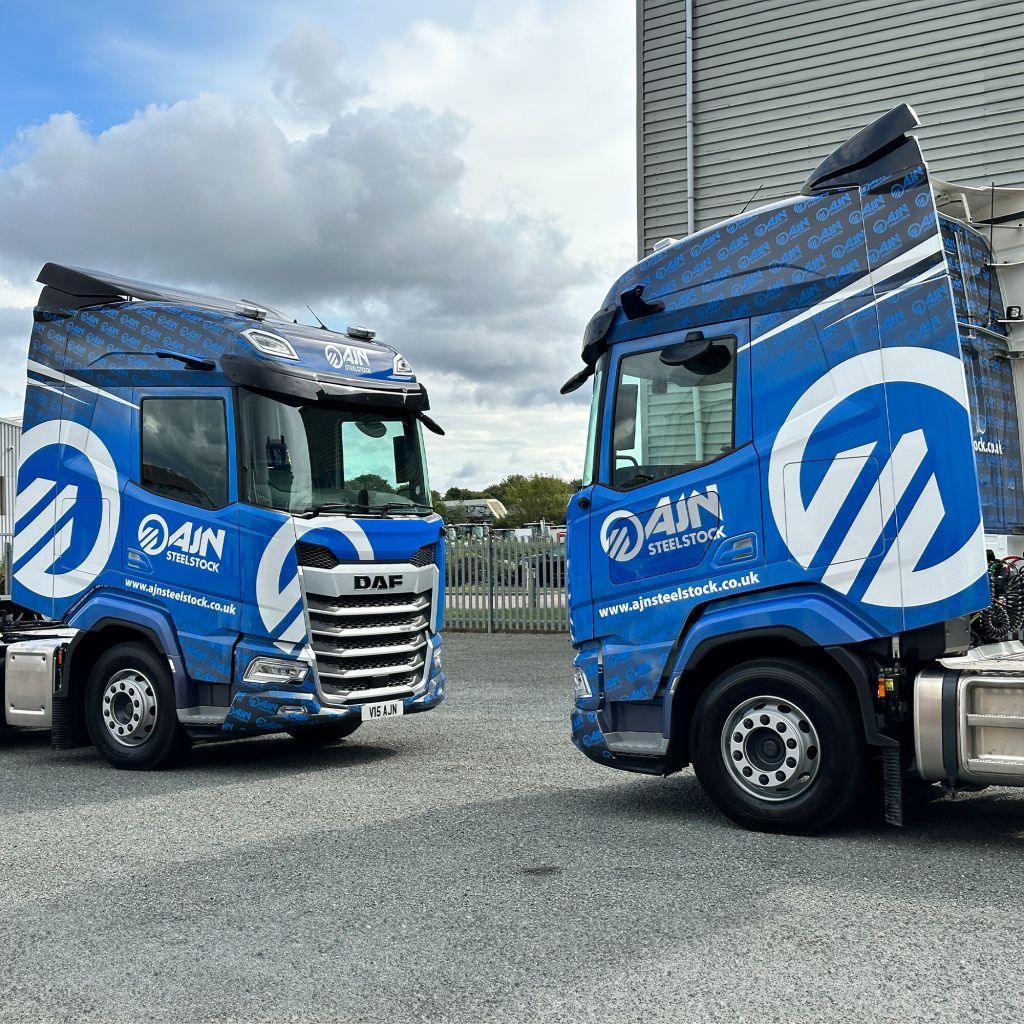 Achieving brand consistency with fleet livery from Indigo Ross, demonstrated by two perfectly matched truck wraps for AJN Steelstock