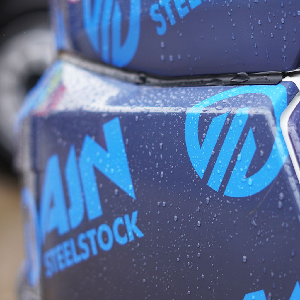 Durable, weather-resistant fleet livery from Indigo Ross, showcased by water beading on the high-quality vinyl wrap of an AJN Steelstock truck