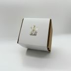 A custom box with a white belly band featuring a gold foil logo. Premium print finishing by Indigo Ross