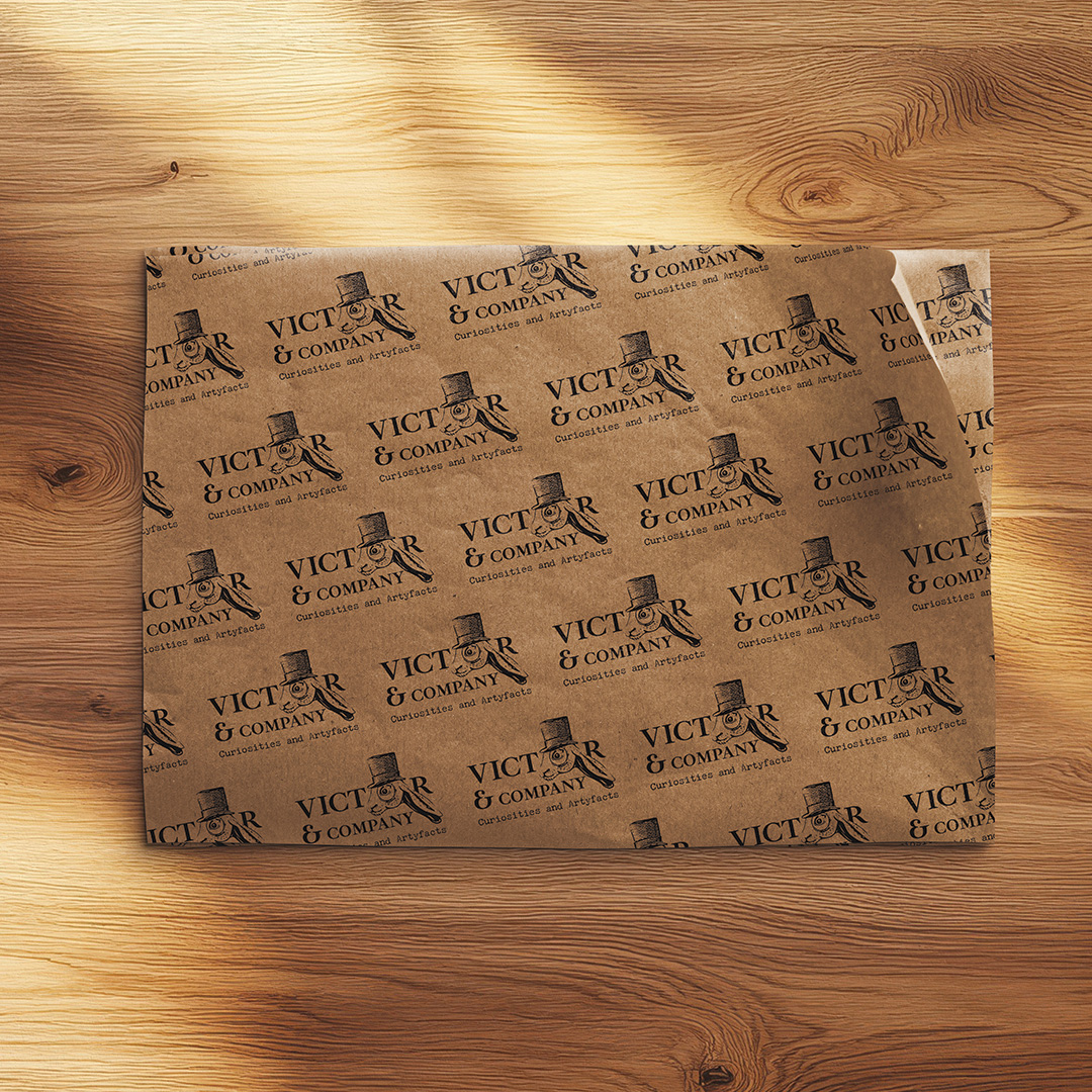 Custom-branded greaseproof paper featuring a step-and-repeat pattern of the Victor & Company logo, used for food service and gift wrapping.