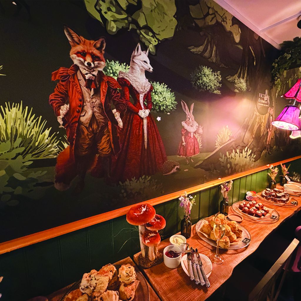 6-metre interior wall mural designed and installed by Indigo Ross, featuring Victorian-dressed fox and hare characters in a seating area.