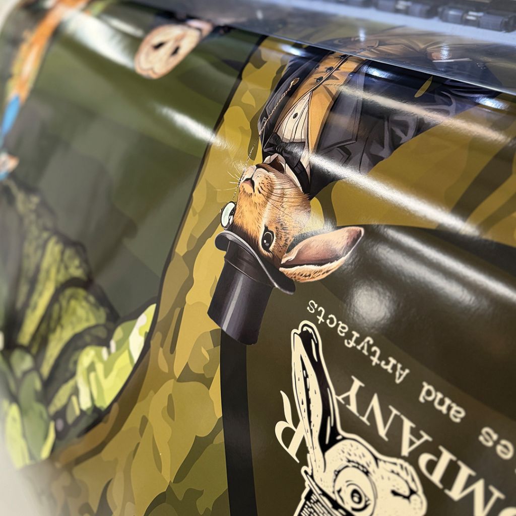 Close-up of a Victorian-inspired character mural being produced on a large-format digital printer at the Indigo Ross studio.